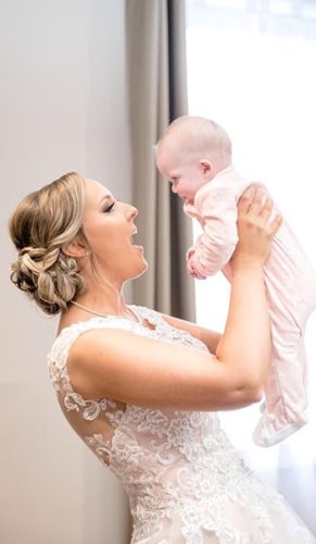 Bride playing with baby